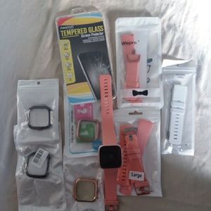 New Fitbit Versa with assortment of accessories.